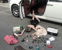 This picture from Wen Siyuan shows a woman lying on the floor as she poses with lipsticks and handbags in Xian as part of the viral 'Wealth-flaunting' meme