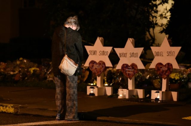 A woman bows her head in front of a memorial at Pittsburgh's Tree of Life synagogue to the 11 people killed October 27 in a mass shooting HIAS, Jewish non-profit with long history of helping refugees