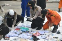 Indonesian police and SAR personel identify personal items of passengers of the ill-fated Lion Air flight JT 610 at the Jakarta port