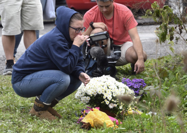 Limousine Crash People place flowers, Sunday, Oct. 7, 2018, at the scene where 20 people died as the result of a limousine crashing into a parked and unoccupied SUV at an intersection a day earlier, in Schoharie, N.Y. (AP Photo/Hans Pennink) The Associated Press