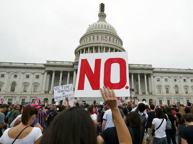 Activists demonstrate in the plaza of the East Front of the U.S. Capitol to protest the confirmation vote of Supreme Court nominee Brett Kavanaugh on Capitol Hill, Saturday, Oct. 6, 2018 in Washington. (AP Photo/Alex Brandon)