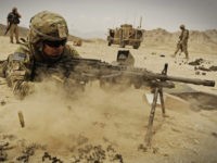 Air Force Master Sgt. Jeffery Needham, staff platoon sergeant attached to Laghman Provincial Reconstruction Team, fires his MK-48 machine gun at wooden targets while practicing at the off-base firing range near Forward Operating Base Mehtar Lam Aug. 6. Members from the PRT and the Security Forces Assistance Team traveled to …