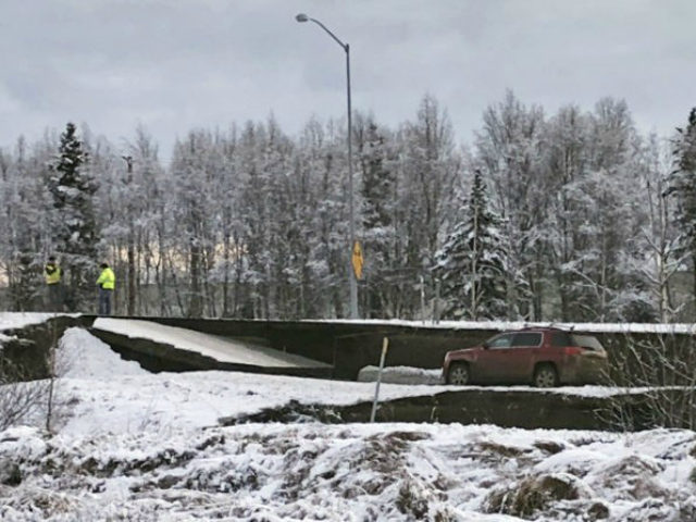 A car is trapped on a collapsed section of the offramp off of Minnesota Drive in Anchorage