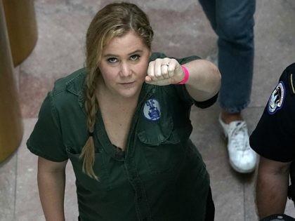 WASHINGTON, DC - OCTOBER 04: Comedian Amy Schumer (L) is led away after she was arrested during a protest against the confirmation of Supreme Court nominee Judge Brett Kavanaugh October 4, 2018 at the Hart Senate Office Building on Capitol Hill in Washington, DC. Senators had an opportunity to review …