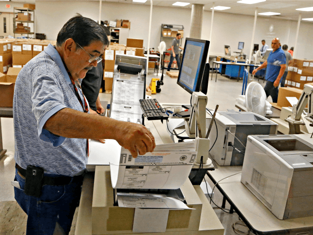 House 2016 Arizona 5th District An Arizona elections official at the Maricopa County Recorder's Office inserts ballots into a machine to recount the votes in the 5th Congressional District race Tuesday, Sept. 13, 2016, in Phoenix. Arizona officials on Tuesday began counting thousands of ballots in the razor-thin Republican primary …