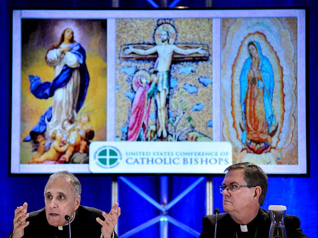 Indiana Bishop Timothy Doherty, chairman of the committee for the Protection of Children and Young People, listens while Galveston-Houston Cardinal Daniel DiNardo, President of the USCCB General Assembly, speaks during a press conference at the annual US Conference of Catholic Bishops November 12, 2018 in Baltimore, Maryland. (Photo by Brendan …