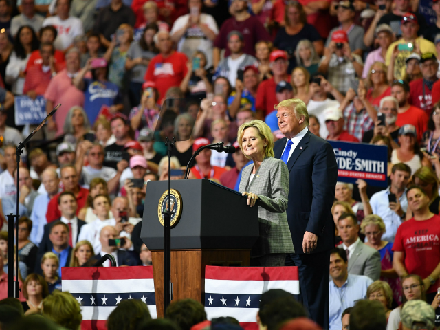 Senator Cindy Hyde-Smith (L) stands on stage with US President Donald Trump at a 'Make America Great Again' rally at Landers Center in Southaven, Mississippi, on October 2, 2018. (Photo by MANDEL NGAN / AFP) (Photo credit should read MANDEL NGAN/AFP/Getty Images)