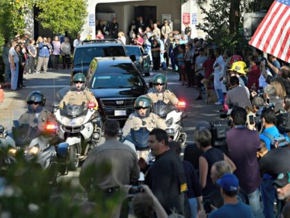 A law enforcement motorcade escorts the body of Ventura County Sheriff's Department Sgt. Ron Helus from the Los Robles Regional Medical Center Thursday, Nov. 8, 2018, in Thousand Oaks, Calif., after a gunman opened fire Wednesday night inside a country music bar killing multiple people including Helus.