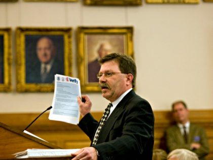 Businessman Chris Barbee holds up a copy of instructions for the E-Verify system at the Statehouse in Topeka, Kan., Wednesday, Feb. 27, 2008. Barbee explained to senators that the electronic process to verify a potential workers citizenship was straightforward and simple to use.