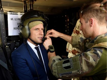 French President Emmanuel Macron (C) gears on for flying over Gao during a visit to the troops of France's Barkhane counter-terrorism operation in Africa's Sahel region in Gao, northern Mali, on May 19, 2017. Macron arrived on May 19 in conflict-torn Mali to visit French troops fighting jihadists on his …