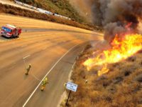 Fire 118 Firefighters work to contain fires at Rocky Peak Mtwy, on state Freeway 118, Monday, Oct. 27, 2003, in Simi Valley, Calif. The 80,000-acre blaze in suburban Simi Valley, 35 miles northwest of Los Angeles, jumped the highway and came within yards of several homes before firefighters began to get the …