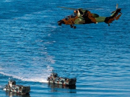 French Tigre attack helicopter supports Dutch Landing Crafts as they carry Finnish and Dutch Marines during a Joint demonstration as part of the NATO Trident Juncture 2018 exercise in Byneset near Trondheim, Norway, October 30, 2018. - Trident Juncture 2018, is a NATO-led military exercise held in Norway from 25 …