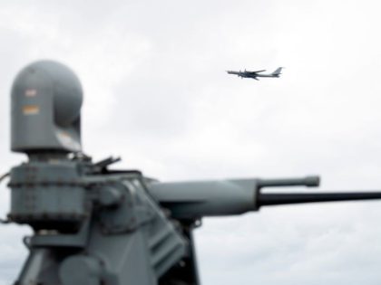 A Russian Tupolev TU-142 flies by the USS Mount Whitney of the US Navy during the NATO-led