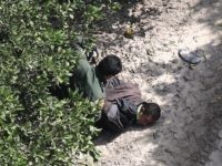 MCALLEN, TX - NOVEMBER 06: U.S. Border Patrol agent detains an undocumented immigrant on November 6, 2018 in McAllen, Texas. Border Patrol agents on the ground, assisted by a helicopter unit of U.S. Air and Marine Operations agents, apprehended a group of immigrants who had crossed the border illegally from …