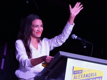 Alexandria Ocasio-Cortez arrives on stage to speak to her supporters during her election n