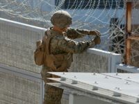 US-MEXICO-MILITARY-POLITICS-BORDER US marines place barbed wire atop fencing along the United States-Mexico border in San Ysidro, California, on November 9, 2018. (Photo by Sandy Huffaker / AFP) (Photo credit should read SANDY HUFFAKER/AFP/Getty Images)