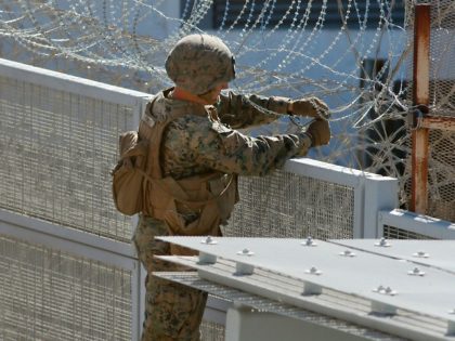 US marines place barbed wire atop fencing along the United States-Mexico border in San Ysidro, California, on November 9, 2018. (Photo by Sandy Huffaker / AFP) (Photo credit should read SANDY HUFFAKER/AFP/Getty Images)