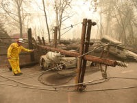 TOPSHOT-US-FIRE-CALIFORNIA-ENVIRONMENT-WEATHER TOPSHOT - CalFire firefighter Scott Wit surveys burnt out vehicles near a fallen power line on the side of the road after the Camp fire tore through the area in Paradise, California on November 10, 2018. - Firefighters in California on November 10 battled raging blazes at both ends of …