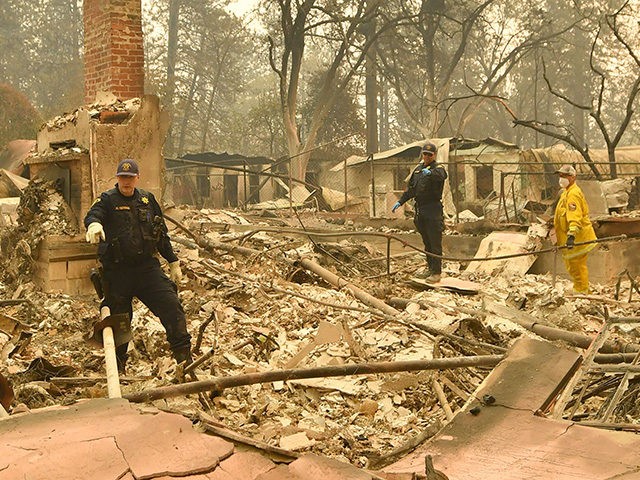 Alameda County Sheriff Coroner officers search for human remains at a burned residence in Paradise, California on November 12, 2018. - Thousands of firefighters spent a fifth day digging battle lines to contain California's worst ever wildfire as the wind-whipped flames cleaved a merciless path through the state's northern hills, …