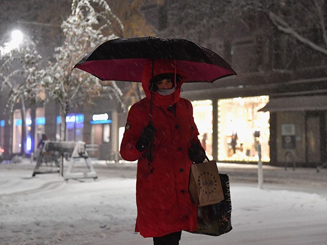 A pedestrian walks through snow in Manhattan on November 15, 2018 in New York City. - The National Weather Service is predicting snowfall totals of 2 to 4 inches in New York City. (Photo by Angela Weiss / AFP) (Photo credit should read ANGELA WEISS/AFP/Getty Images)