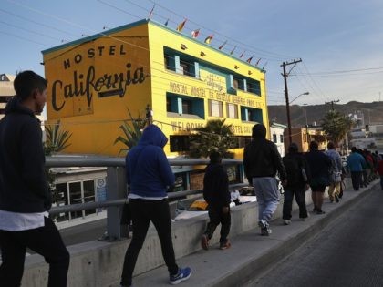 TIJUANA, MEXICO - NOVEMBER 17: Members of the migrant caravan walk to the official border