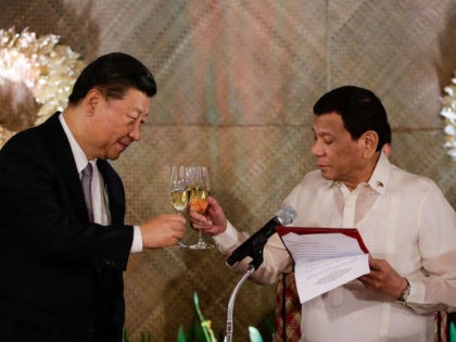 Chinese President Xi Jinping (L) and Philippines' President Rodrigo Duterte (R) raise a to