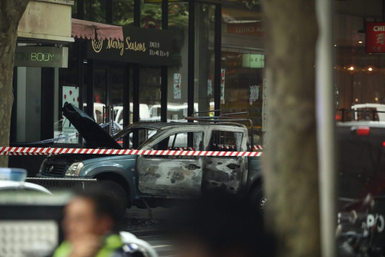 MELBOURNE, AUSTRALIA - NOVEMBER 09: A burnt out vehicle is seen in Bourke St on November 09, 2018 in Melbourne, Australia. A man has been shot by police after setting his car on fire and stabbing several people in Bourke St mall in Melbourne's CBD this afternoon. The man was arrested at the scene and has been taken to hospital under police guard in a critical condition. (Photo by Robert Cianflone/Getty Images)