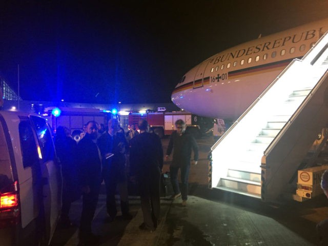 People gather around German Chancellor's Airbus "Konrad Adenauer" on November 29, 2018 on the tarmac of Cologne's airport after an emergency landing. - German Chancellor Angela Merkel will miss the opening of the G20 summit in Argentina after her plane was forced to make an emergency landing in Cologne due …