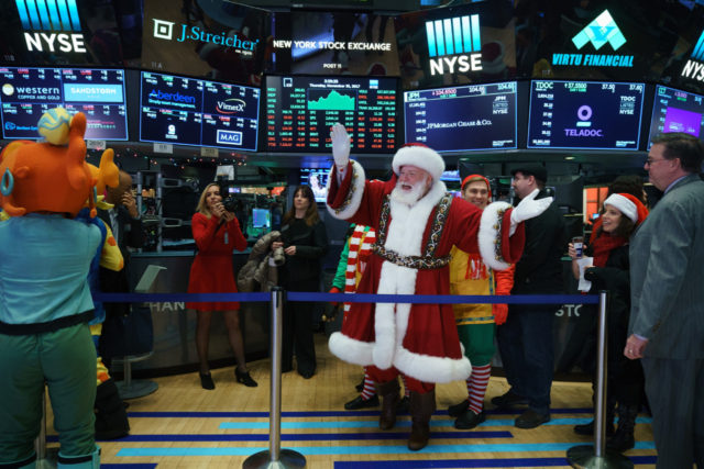 NEW YORK, NY - NOVEMBER 30: A man dressed as Santa Claus visits the floor of the New York