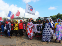 Protesters hold French and Mayotte flags as they gather on the Place de la Republique in Mamoutzou, on the French Indian Ocean island of Mayotte, on March 13, 2018, during a demonstration against insecurity and immigration. The French government attempted on March 12 to end weeks of unrest on the …
