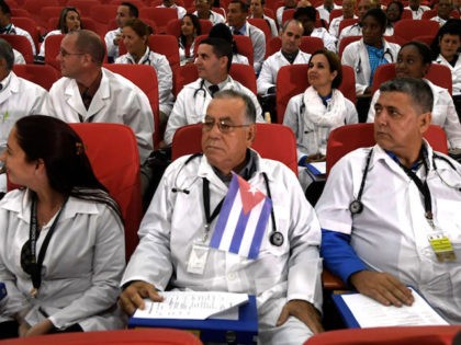 Some 100 Cuban doctors follow proceedings during their induction programme at the Kenya Sc