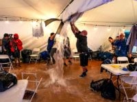 TALLAHASSEE, FL - NOVEMBER 06: One of the members of the media cuts a whole in the ceiling of the press tent as they evacuated the media just before the start of Florida Democratic gubernatorial candidate Andrew Gillum's election night watch party at Florida A&M University on November 6, 2018 …