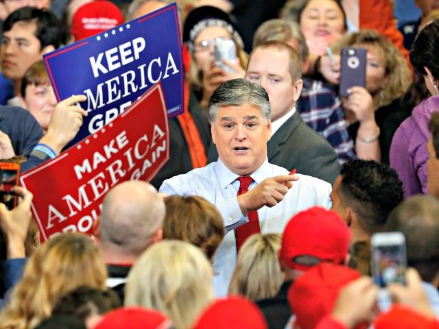 Television personality Sean Hannity speaks to members of the audience while signing autogr