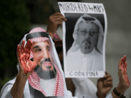 A demonstrator dressed as Saudi Arabian Crown Prince Mohammed bin Salman (C) with blood on
