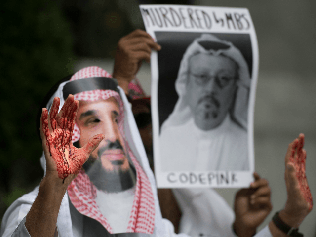 A demonstrator dressed as Saudi Arabian Crown Prince Mohammed bin Salman (C) with blood on his hands protests outside the Saudi Embassy in Washington, DC, on October 8, 2018, demanding justice for missing Saudi journalist Jamal Khashoggi. - US President Donald Trump said October 10, 2018 he has talked to Saudi authorities 'at the highest level' to demand answers over what happened to missing journalist Jamal Khashoggi. Trump told reporters at the White House that he talked to the Saudi leadership 'more than once' since Khashoggi, a US resident and Washington Post contributor, vanished on October 2 after entering the Saudi consulate in Istanbul. (Photo by Jim WATSON / AFP) (Photo credit should read JIM WATSON/AFP/Getty Images)