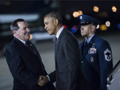 US President Barack Obama (C) is greeted by Senator Joe Donnelly (L), D-IN, at Gary Chicago International Airport October 1, 2014 in Gary, Indiana. Obama will attend a campaign event for Gov. Pat Quinn, D-Il, and deliver remarks on the economy at Northwestern University. AFP PHOTO/Brendan SMIALOWSKI (Photo credit should …