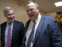 Jon-Tester-smile-Capitol-ap Sen. Jon Tester (right) leaves the Capitol following votes. (AP Photo/J. Scott Applewhite)