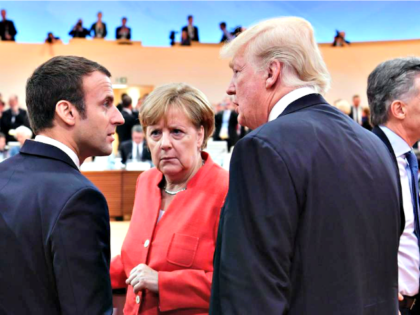 Mr Macron jumped through world leaders to stand next to Mr Trump