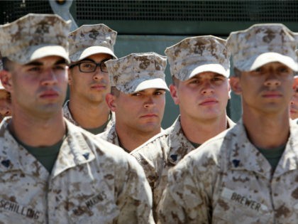 Marines and sailors maintain formation while awaiting release to join nearby loved ones as