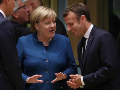 BRUSSELS, BELGIUM - OCTOBER 17: German Chancellor Angela Merkel and French President Emmanuel Macron chat prior to a meeting of EU leaders to discuss Brexit at the European Council on October 17, 2018 in Brussels, Belgium. British Prime Minister Theresa May is to address the assembled 27 European Union leaders …