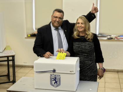 Mayoral candidate Moshe Lion, left, and his wife pose for the media as they cast their vot