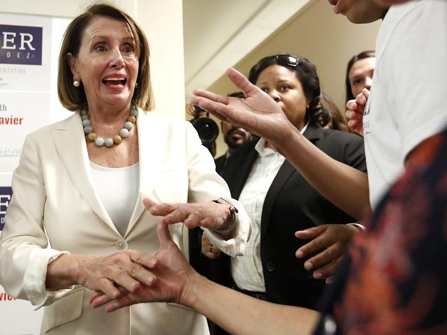 House Minority Leader Nancy Pelosi, left, greets volunteers before a get out the vote even