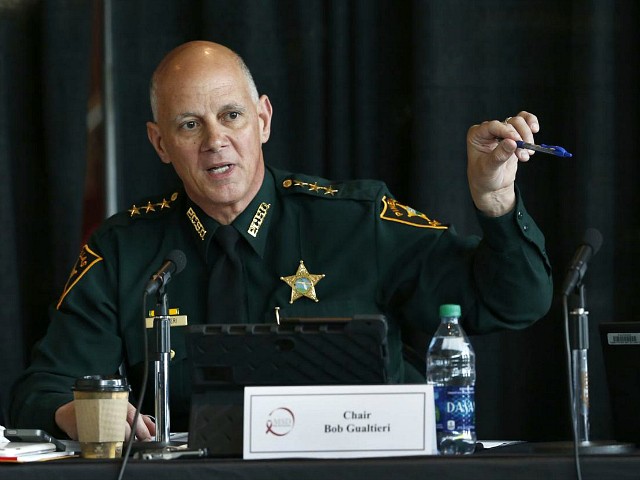 FILE- In this June 7, 2018 file photo Marjory Stoneman Douglas High School Public Safety Commission chair and Pinellas County Sheriff Bob Gualtieri gestures as he speaks during a commission meeting in Sunrise, Fla. Guiltieri says he now believes trained, volunteer teachers should have access to guns so they can stop shooters who get past other safeguards. (AP Photo/Wilfredo Lee, File)