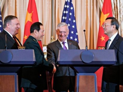 From left, Secretary of State Mike Pompeo, Chinese State Councilor and Defense Minister General Wei Fenghe, Secretary of Defense Jim Mattis, and Chinese Politburo Member Yang Jiechi shake hands at the conclusion of a news conference at the State Department in Washington, Friday, Nov. 9, 2018.
