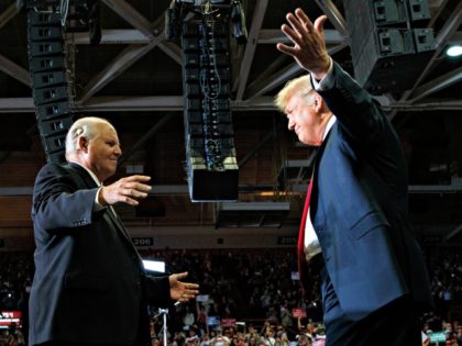 President Donald Trump opens his arms to Rush Limbaugh as he arrives to speaks during a rally at Show Me Center, Monday, Nov. 5, 2018, in Cape Girardeau, Mo.