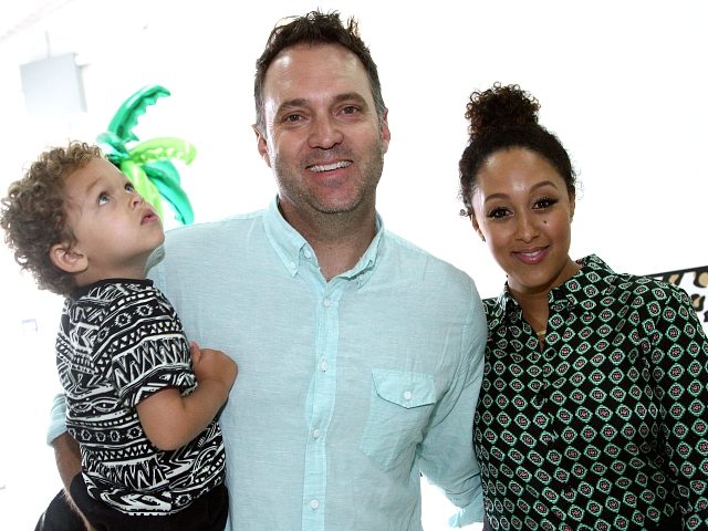 CULVER CITY, CA - APRIL 24: Journalist Adam Housley (C) and Tamera Mowry-Housley (R) atten