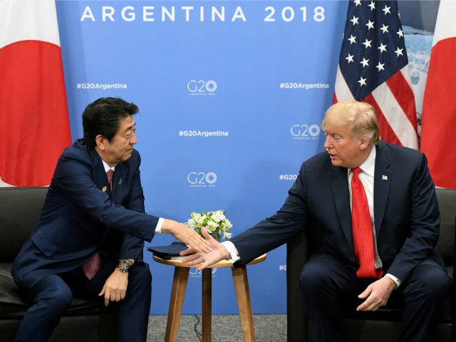 Japan's Prime Minister Shinzo Abe (L) and US President Donald Trump shake hands during a b