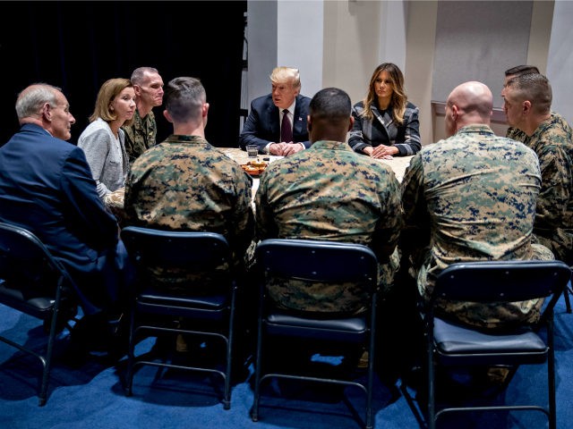 U.S. President Donald Trump, and First Lady Melania Trump listen while speaking to Marines