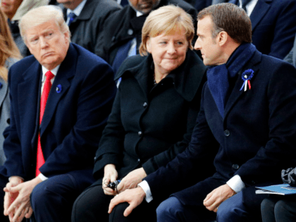 TOPSHOT - French President Emmanuel Macron (R) touches the knee of German Chancellor Angela Merkel (2nd R) as they sit next to US President Donald Trump (2nd L) and US First Lady Melania Trump (L) during a ceremony at the Arc de Triomphe in Paris on November 11, 2018 as …