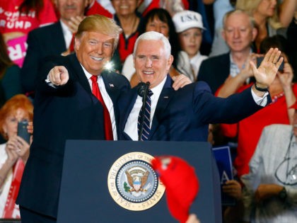 In this Nov. 3, 2018, file photo, President Donald Trump and Vice President Mike Pence wave to supporters at a rally, in Pensacola, Fla. Japan’s Chief Cabinet Secretary Yoshihide Suga announced Thursday, Nov. 8, that Pence will hold talks with Prime Minister Shinzo Abe and other top officials during his …